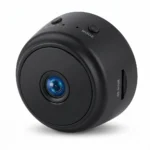 Компактна черна мини WiFi камера със слот за Micro SD карта, бутони за включване и режим, представена на чист бял фон, идеална за дискретно наблюдение, надеждна защита и вашето пълно спокойствие.