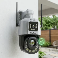 Външна Wi-Fi камера FipTec LO38 с две лещи, монтирана на бяла стена. Зеленият символ за сигурност гарантира надеждна охрана и дискретна защита за вашето пълно спокойствие и лесен контрол.